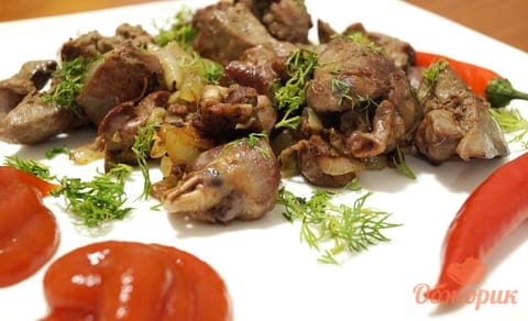 Fried chicken livers and hearts with soft onion, scattered with parsley